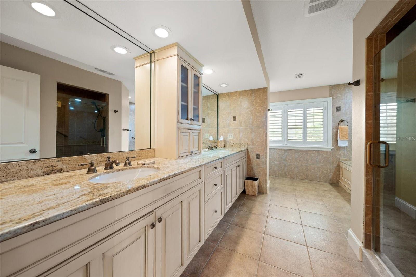 Primary bath room has walk in shower and soaking tub.