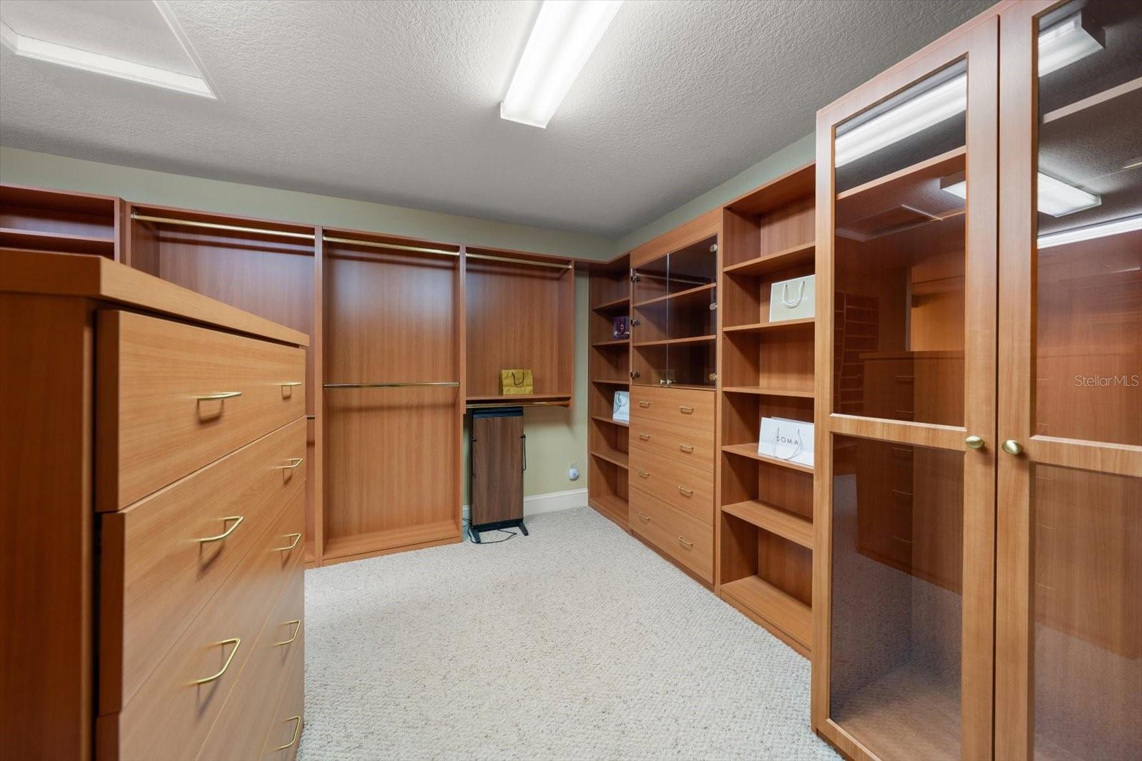 Personalized to perfection, this is a fabulous primary closet with all the storage one could hope for.