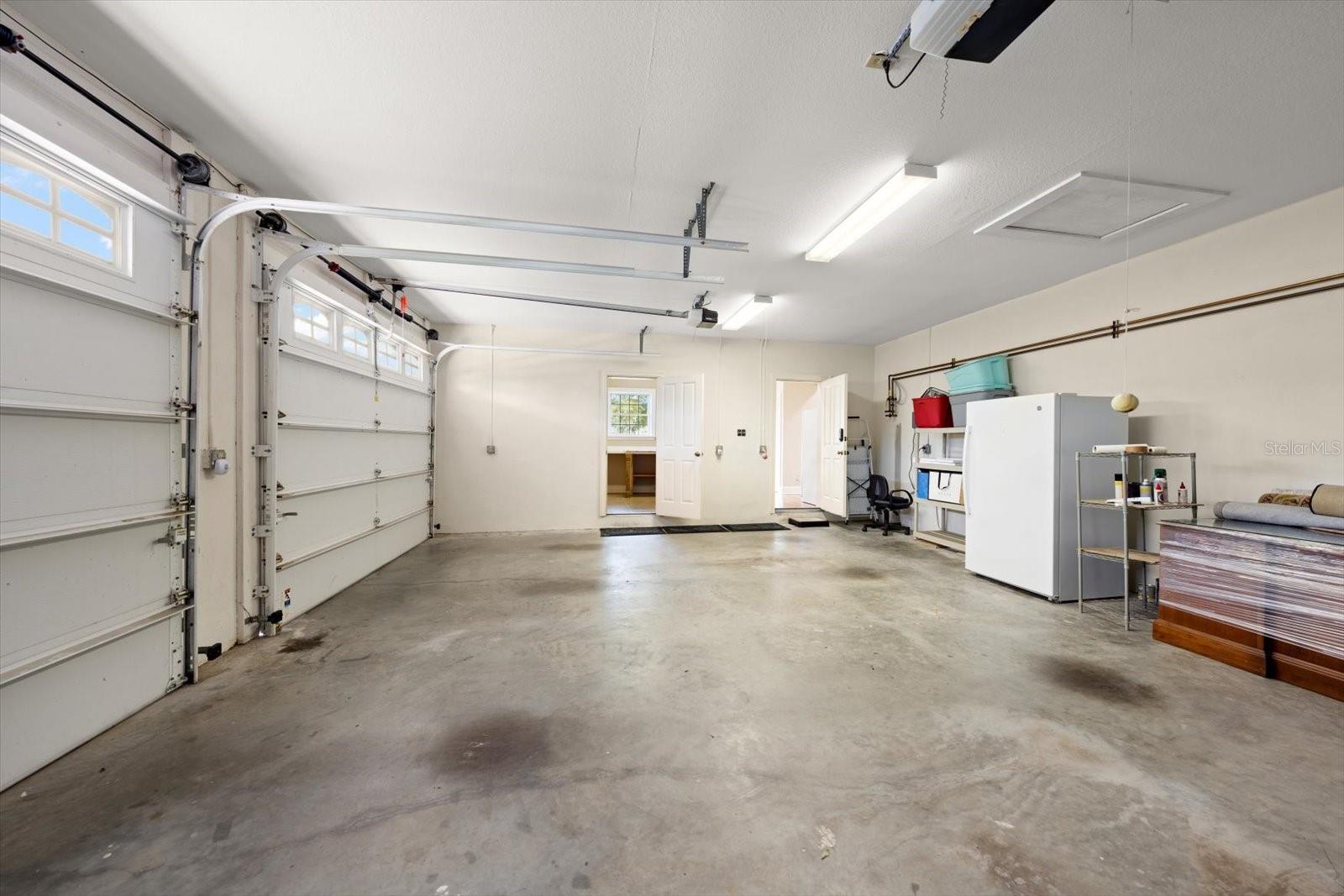 Garage area with separate entry to climate controlled work shop and storage.