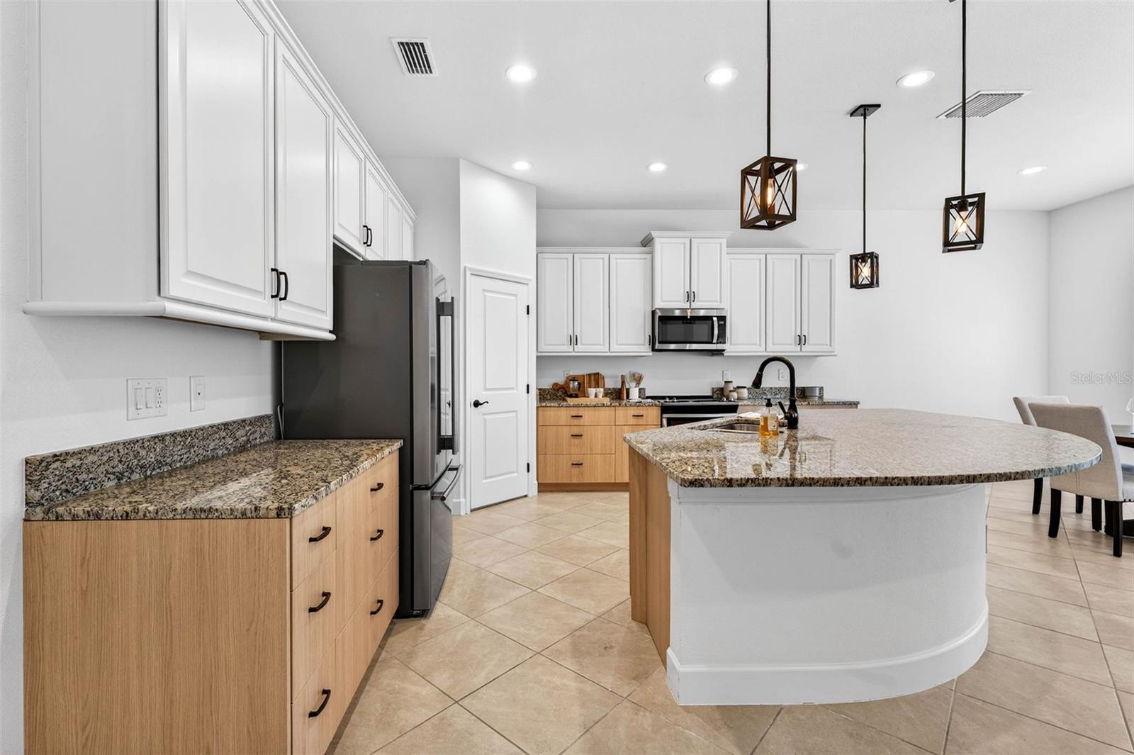 Plenty of room in the kitchen and island to add casual seating.