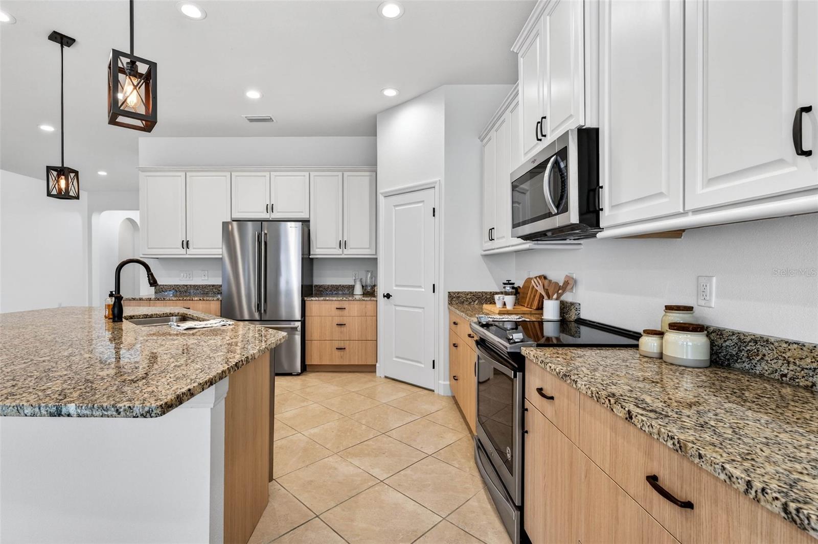 Stainless steel appliances, overhead lighting, upgraded cabinetry.