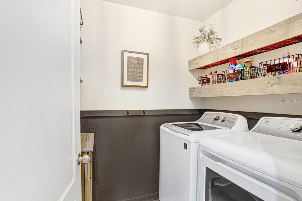Laundry Room with shelving and cabinet