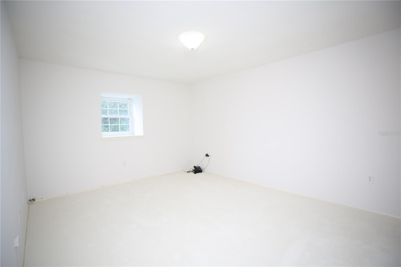 Master bedroom has white carpeting and en-suite bath