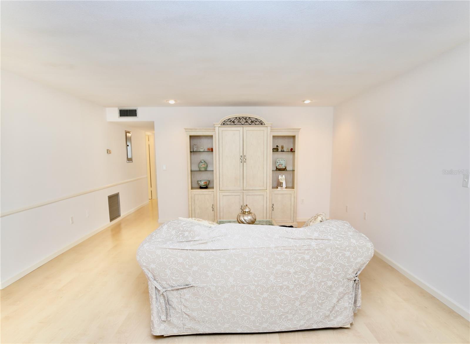 Spacious living room with maple flooring