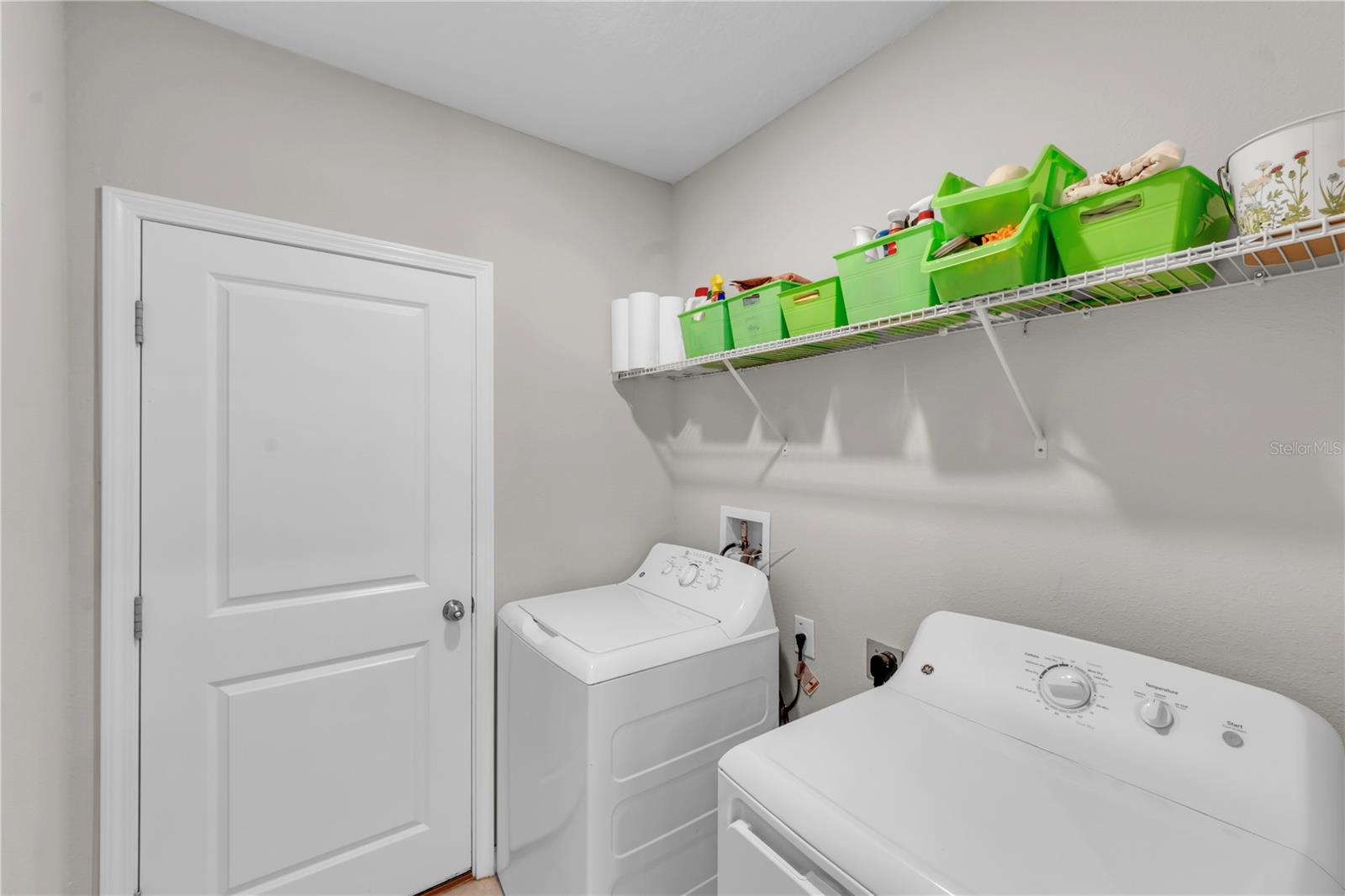 Laundry room leading to 2-car garage
