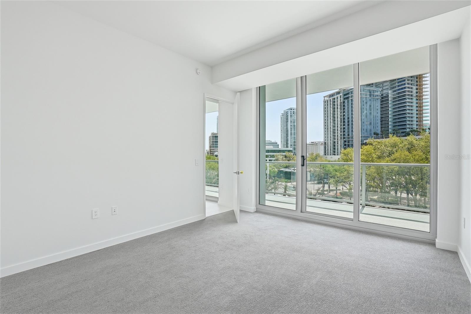 First floor guest bedroom with access to balcony