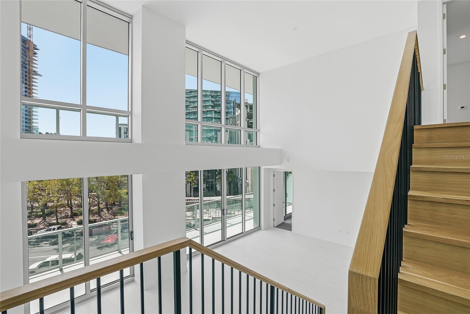 Magnificent City Home with a two-story ceiling and beautiful wood stairs to the second-floor primary suite.