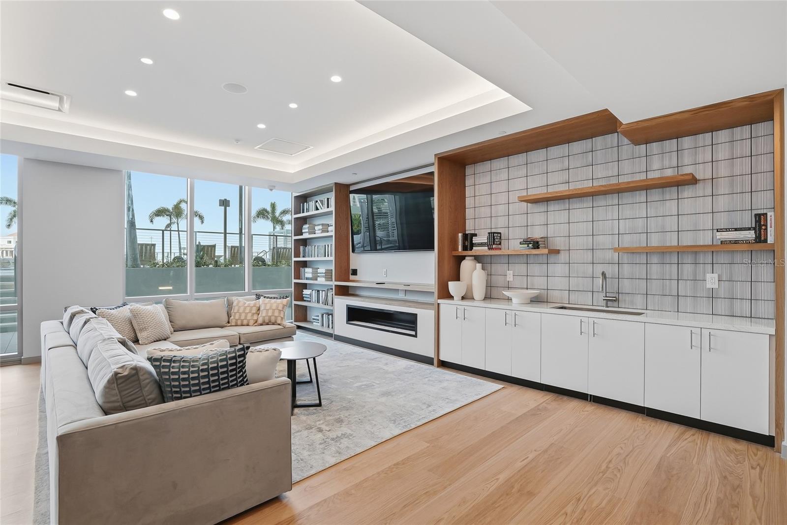 Comfortable social room just inside the pool deck for hanging out or reserving for parties