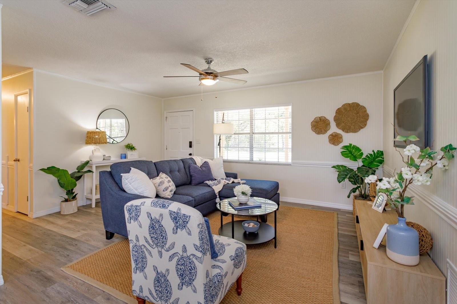 Enter in to a beautiful living room! Bead board and chair rail.