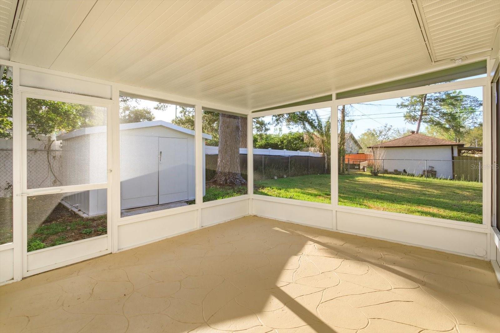 Rear patio off of flex room/kitchen! Shed!