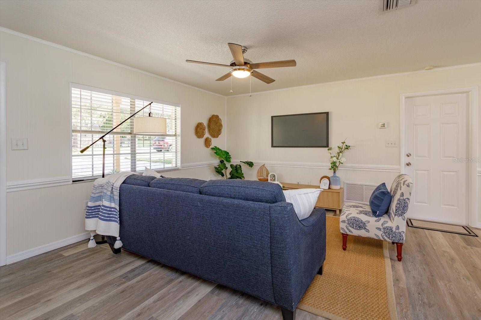 Ceiling fan, new blinds and door out to the garage.