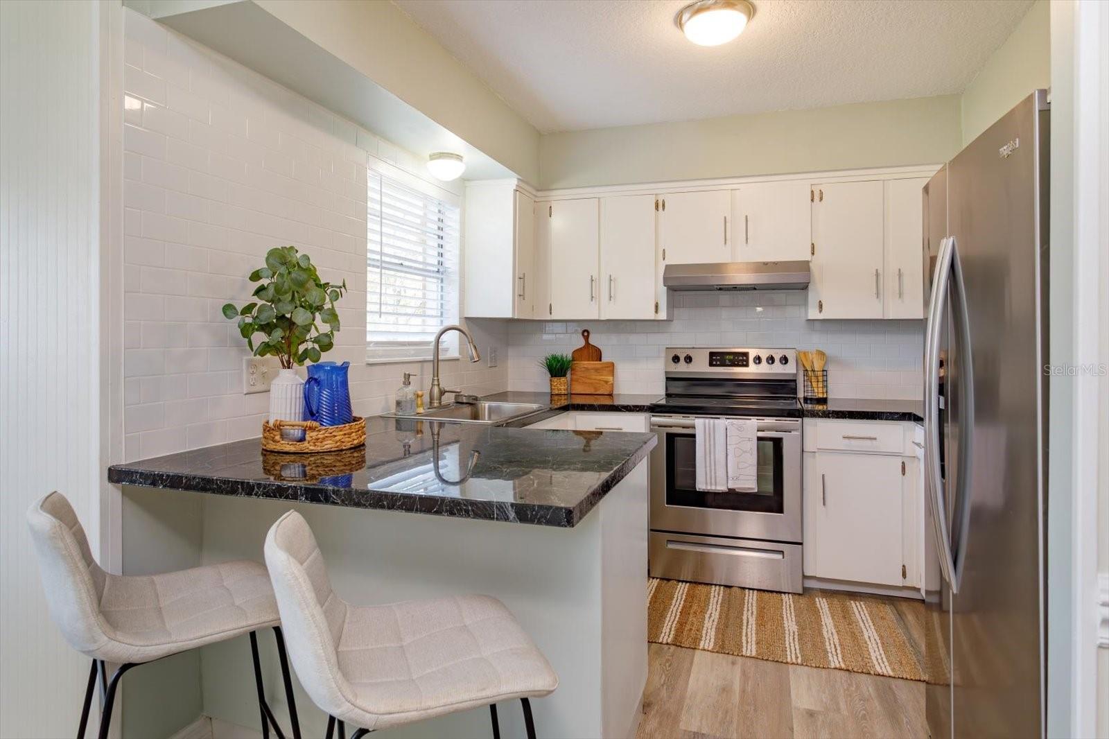 Freshly updated kitchen with new subway tile backsplash and fresh paint!