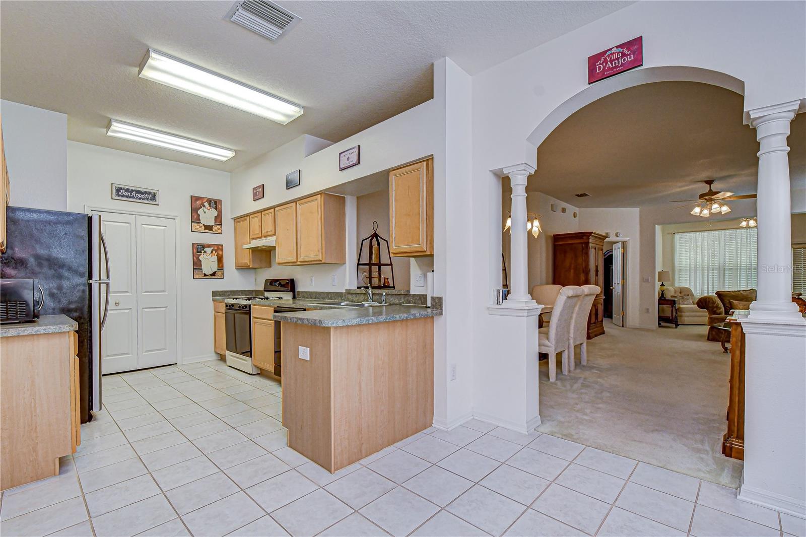 The open kitchen is ready for a new chef! The laundry closet is on the far wall of the kitchen.