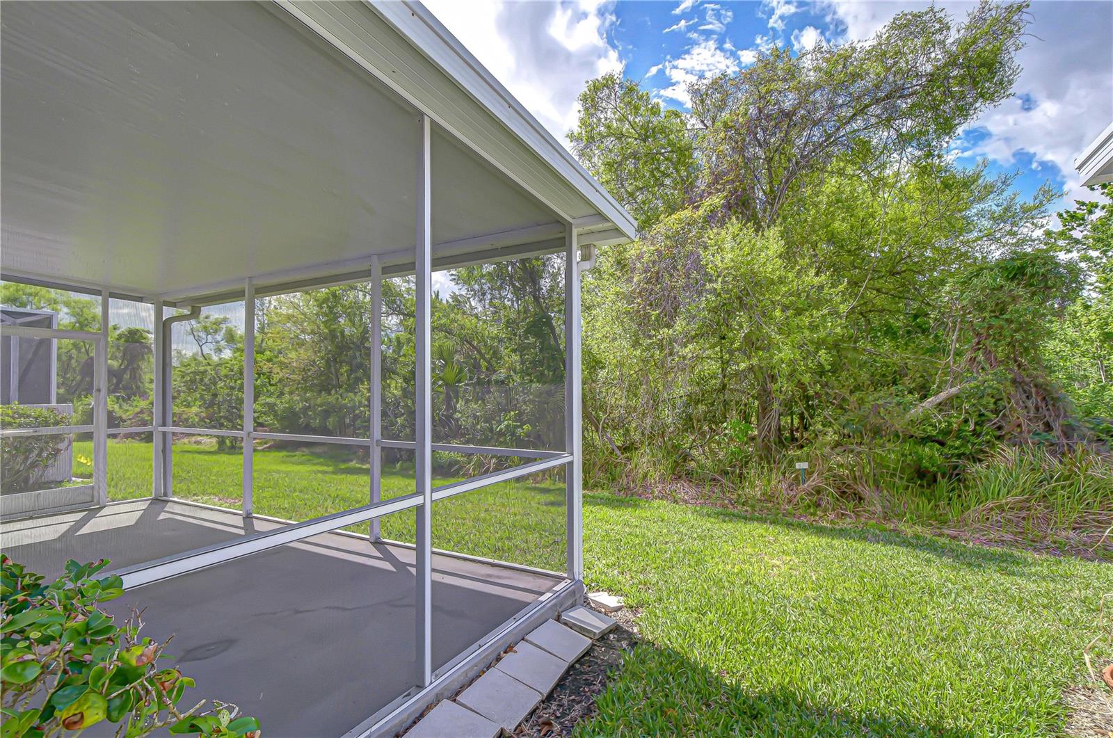 A large screened and covered lanai welcomes one to watch the wildlife in the back yard!