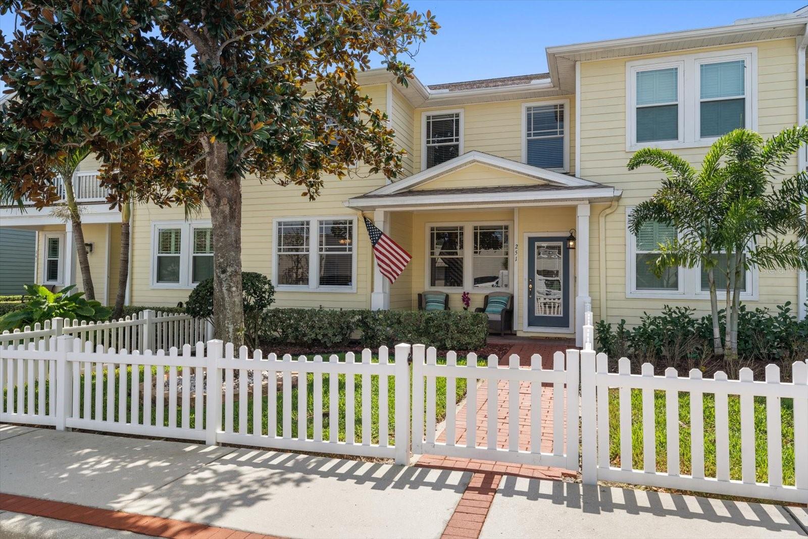 Front of home, covered porch & brick walkway