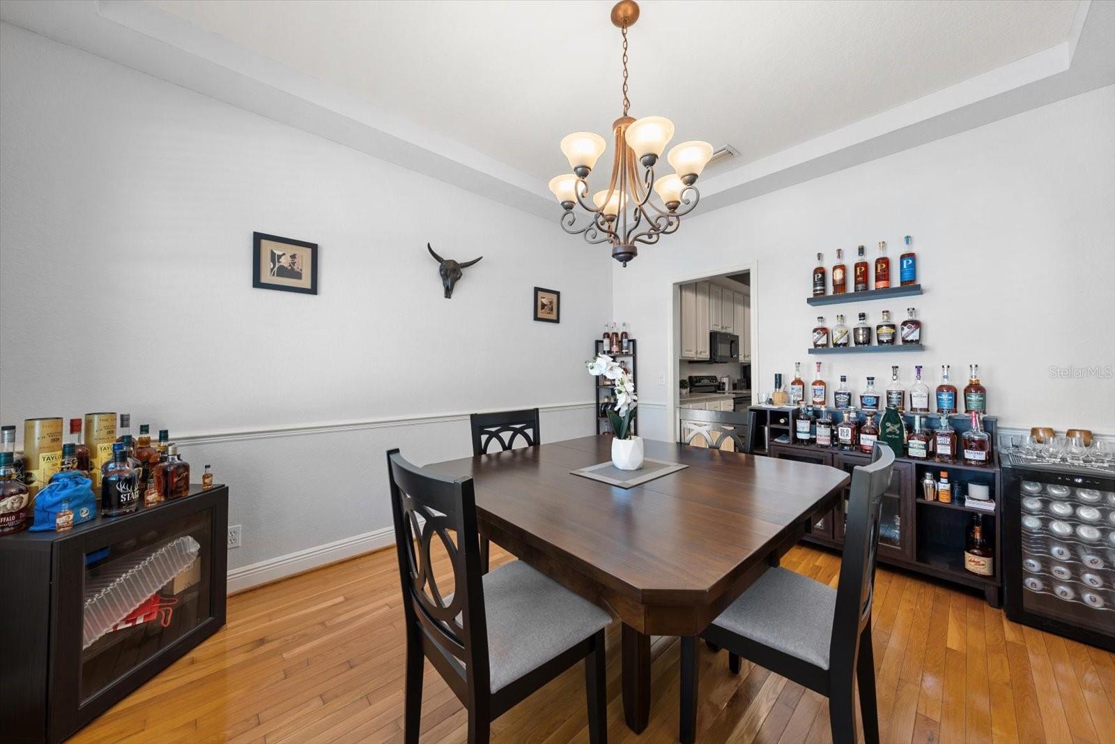 Dining room with hardwood floors and chair rail.