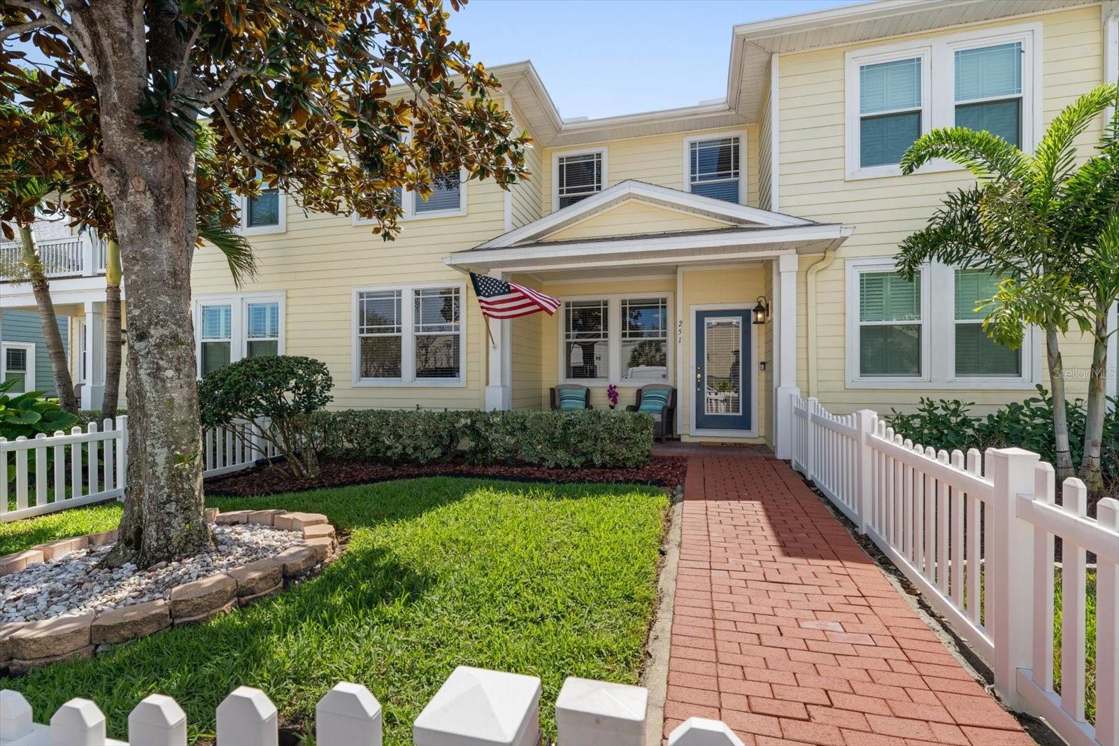 Front of home, covered porch & brick walkway