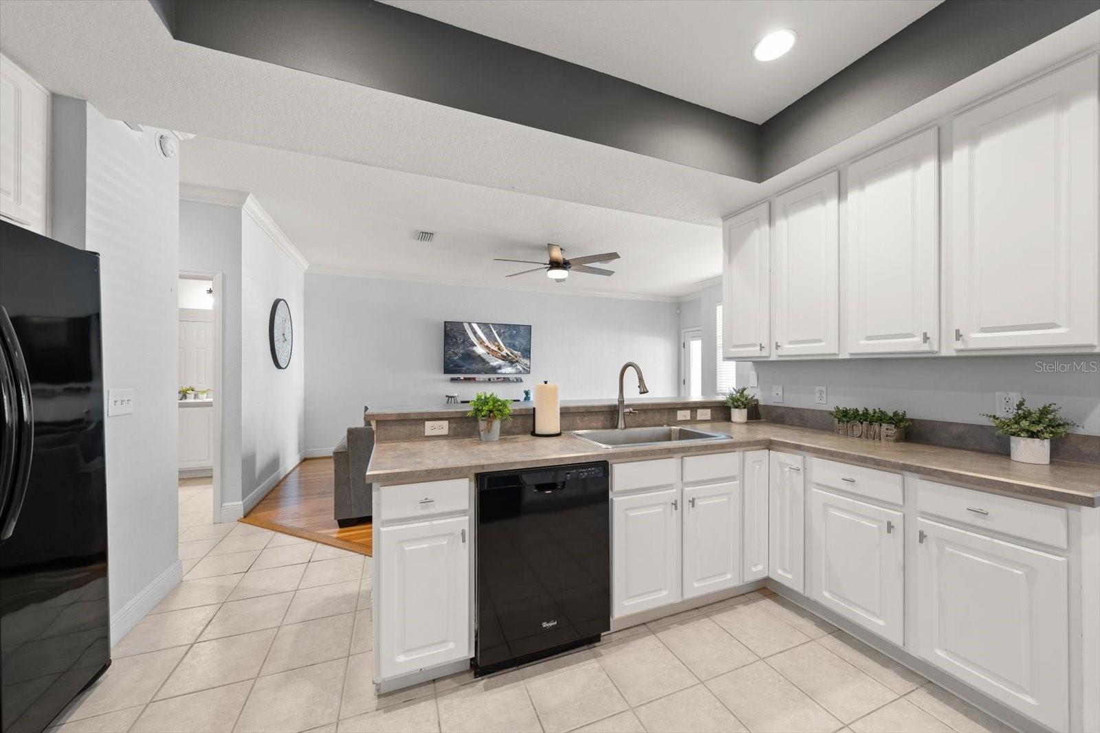 Kitchen with tray ceiling, open to living room