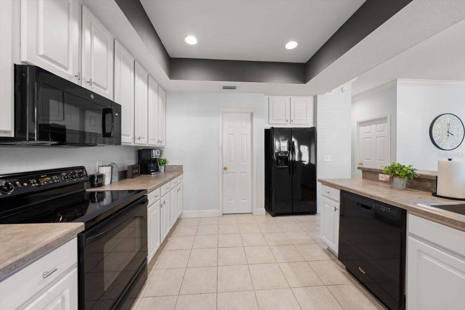 Kitchen with tray ceiling and closet pantry