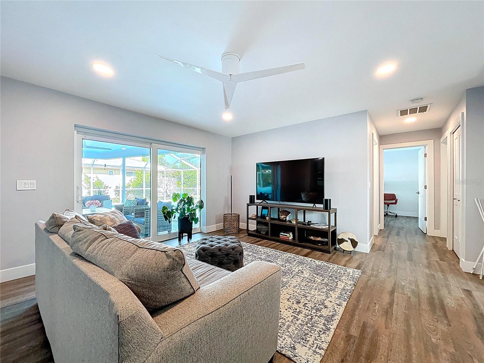Two living rooms, both with views of the pool.