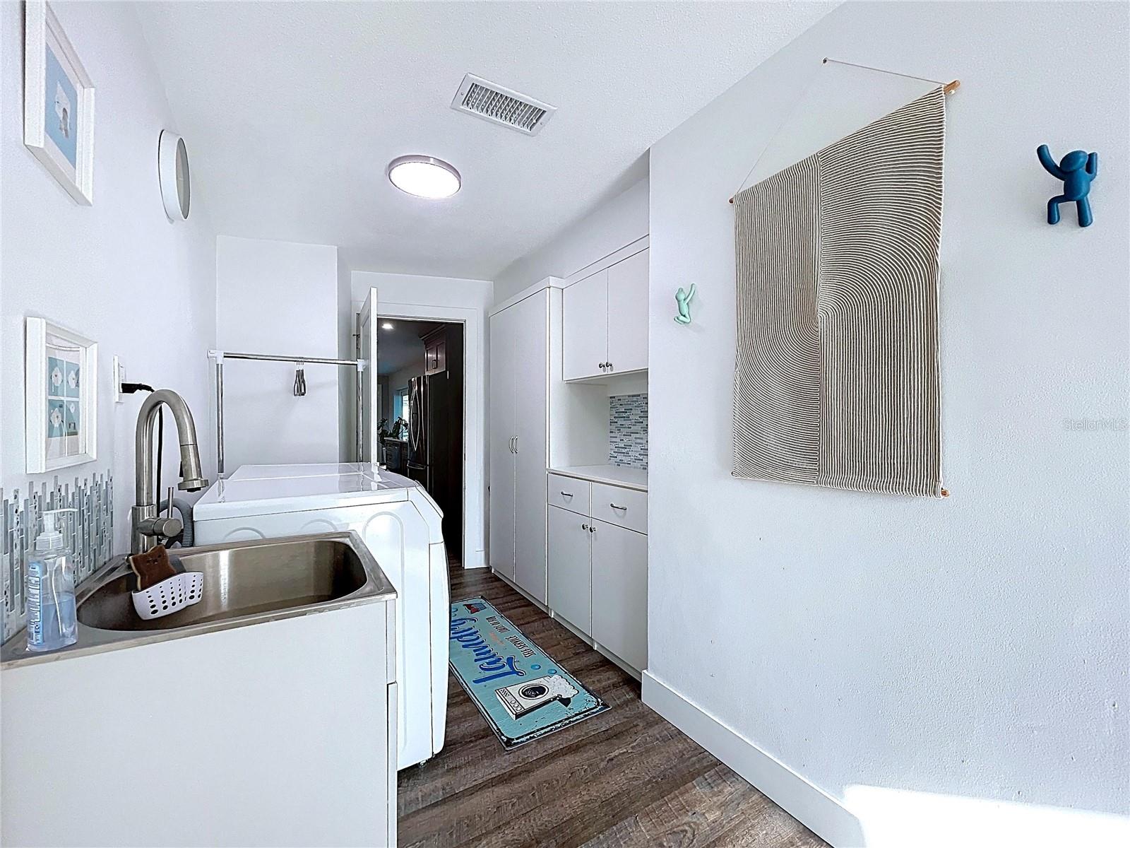 The inside laundry room is complete with a laundry sink.