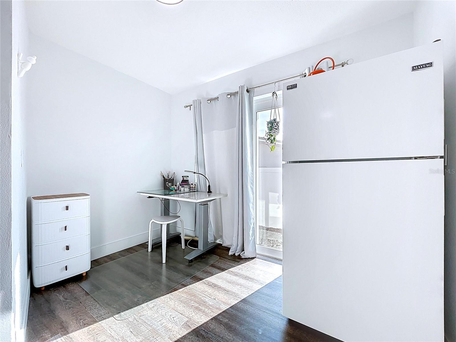 The laundry room offers ample storage and built in cabinets.