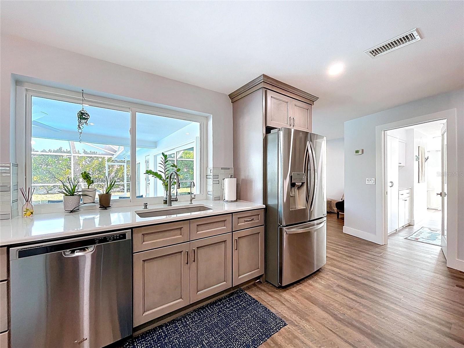 Fully updated and open kitchen with stainless appliances.