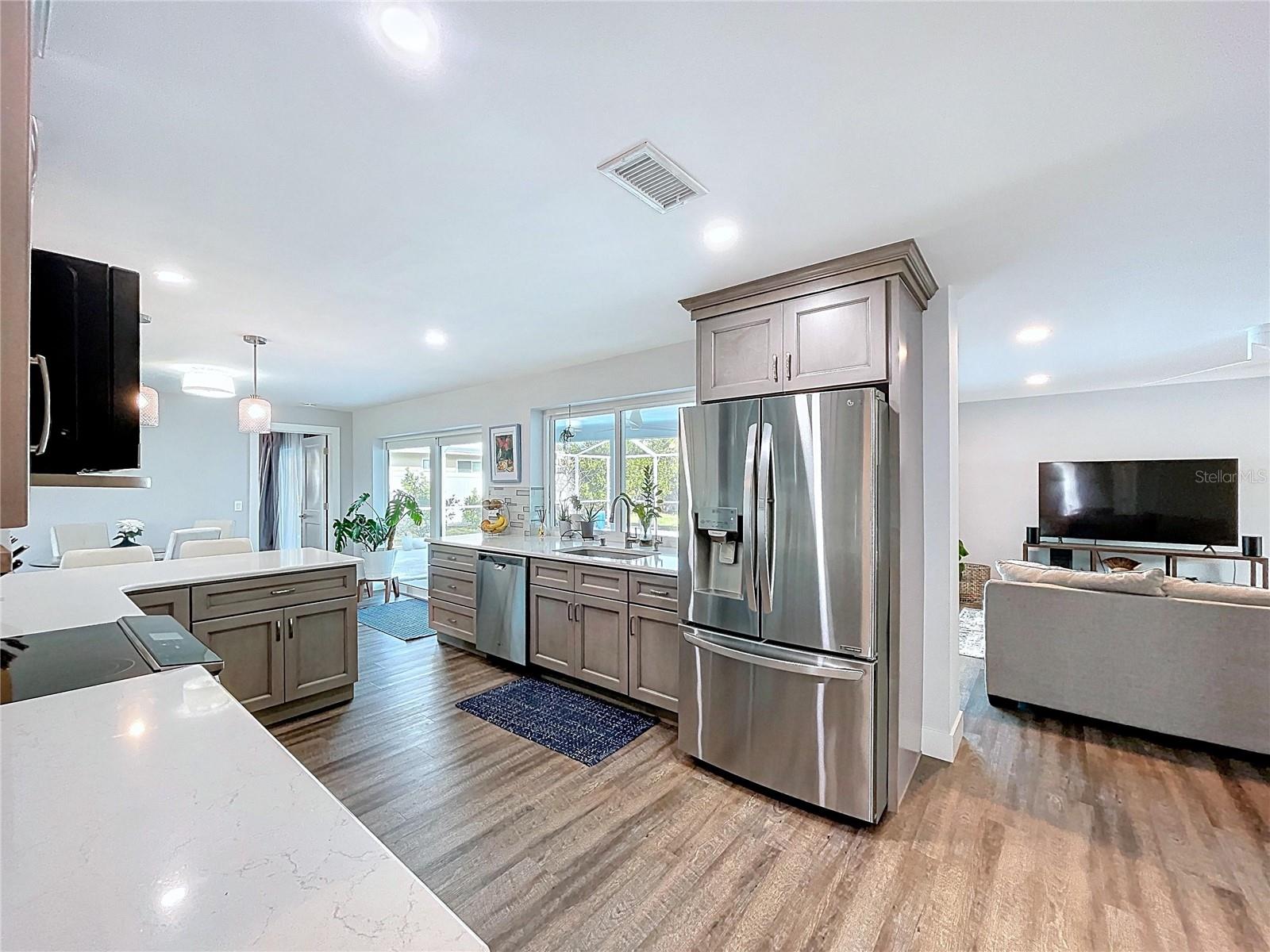 Fully updated kitchen with views of the pool and plenty of natural light.