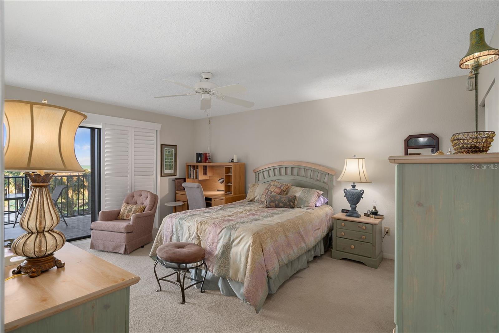 Primary bedroom features sliders to the patio & overlooks the beach