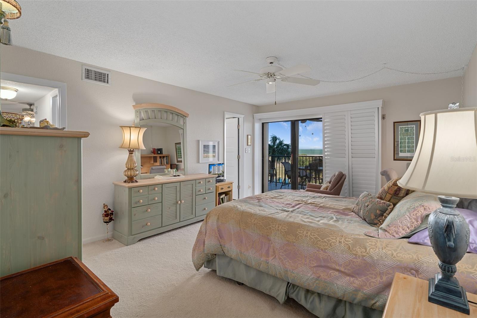 Primary suite offers great views and salty breezes through the sliding doors to patio