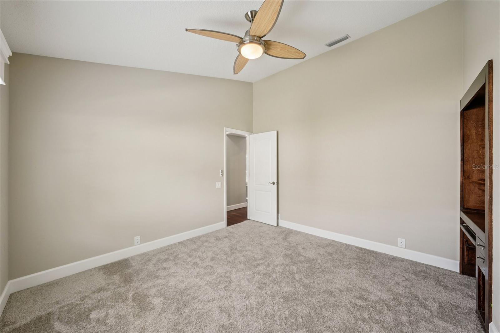 Bedroom three features vaulted ceilings, new carpet, built-in desks, wall closets, and modern ceiling fans.
