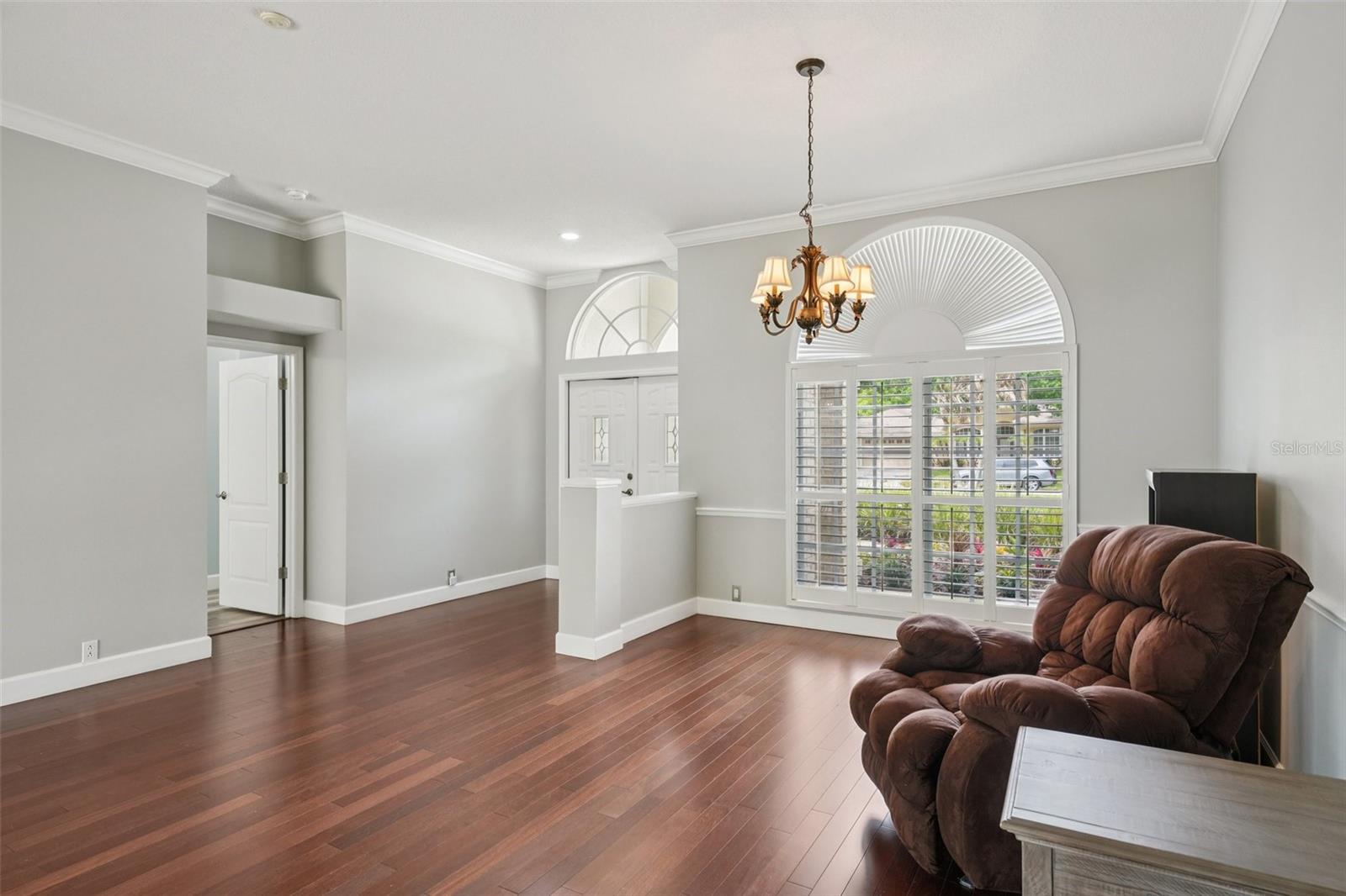 Dining room off foyer with large front facing window and gorgeous cherry engineered hardwood flooring.
