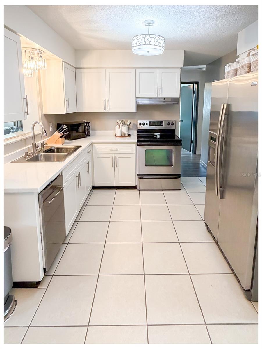 The kitchen has NEW cabinets, NEW quartz counter tops and stainless steel appliances.