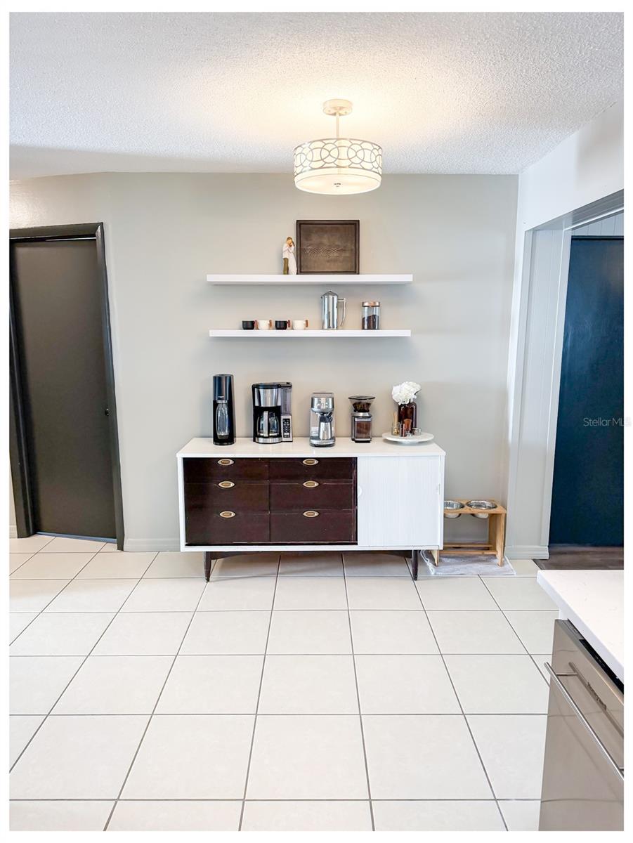 This area is being used as a coffee bar but would also work for a small kitchen table.