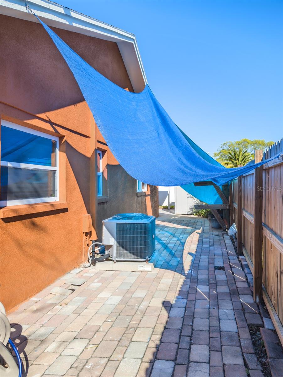 side pavered patio area that could be just for the mother in law suite