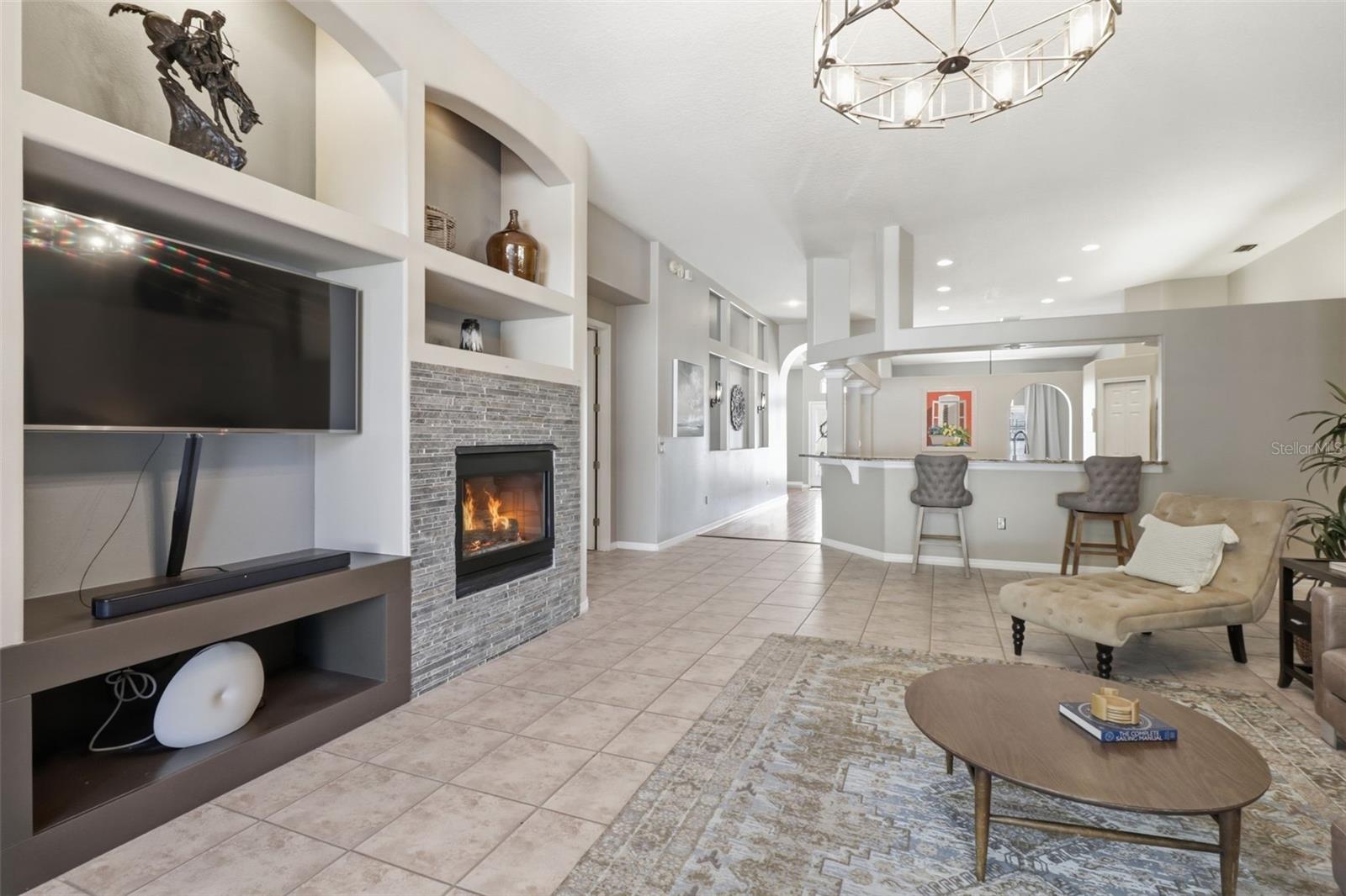 Spacious open layout with fireplace and built-ins, designed for comfortable living and entertaining