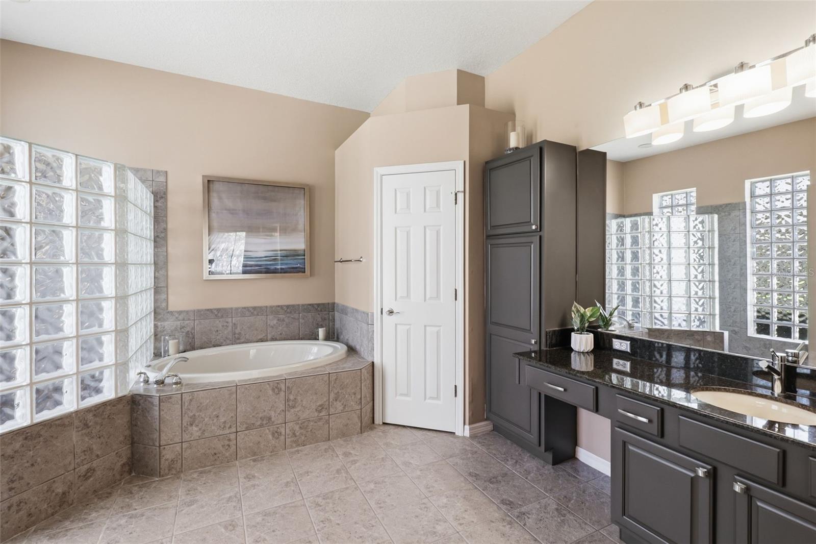 Relaxing primary bathroom with soaking tub, separate shower, and plenty of space to unwind