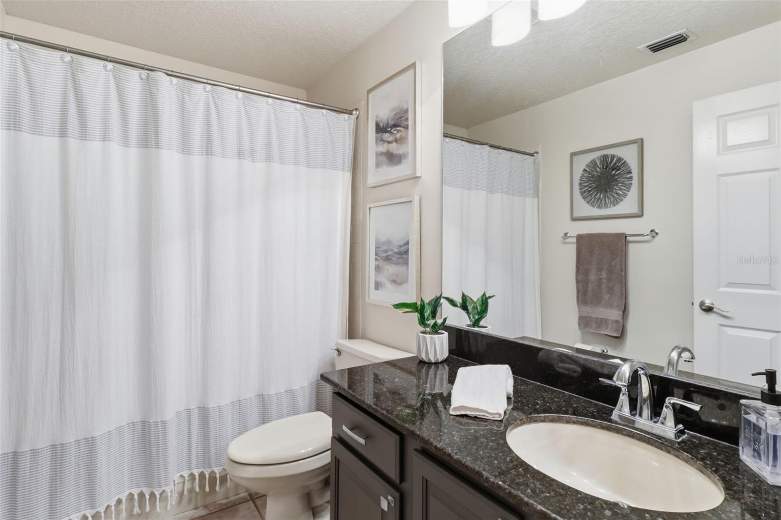 Full bathroom with vanity and tub/shower combination