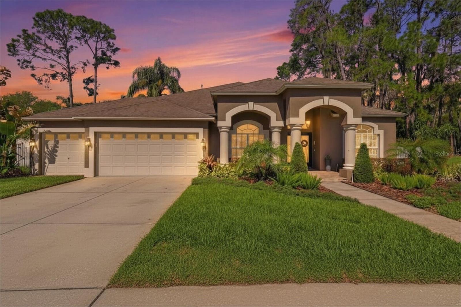 Beautiful front exterior at sunset showcasing warm lighting and inviting curb appeal