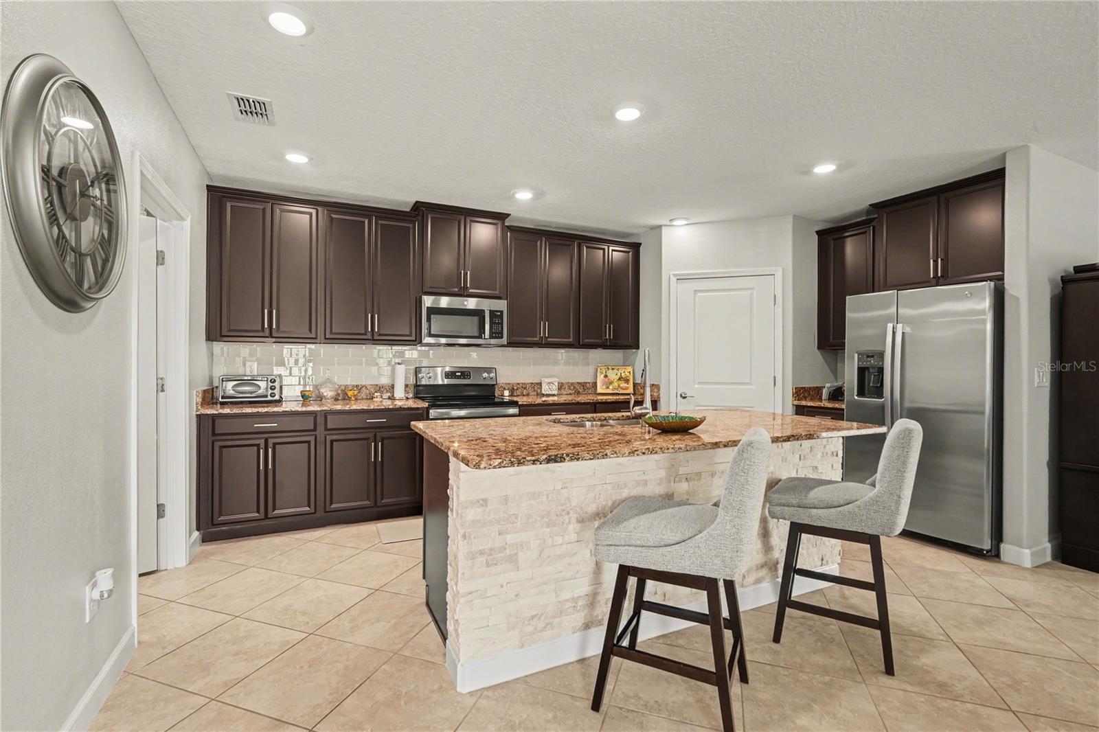 Custom painted cabinets with stunning backsplash