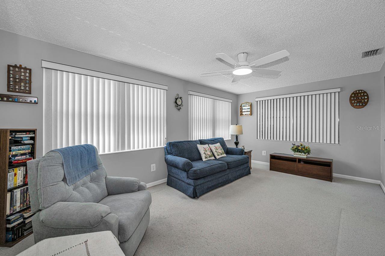 This bright and spacious family room looks out over the rear of property.