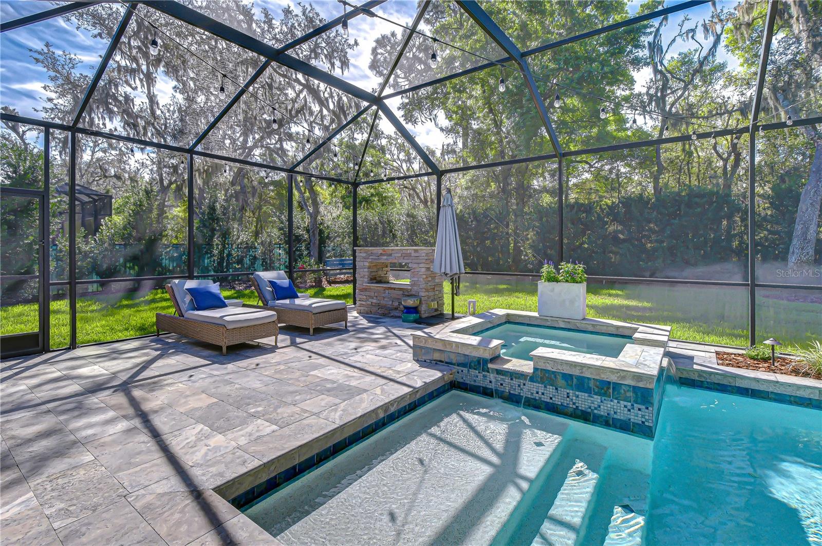 Updated travertine lanai ideal for entertaining.