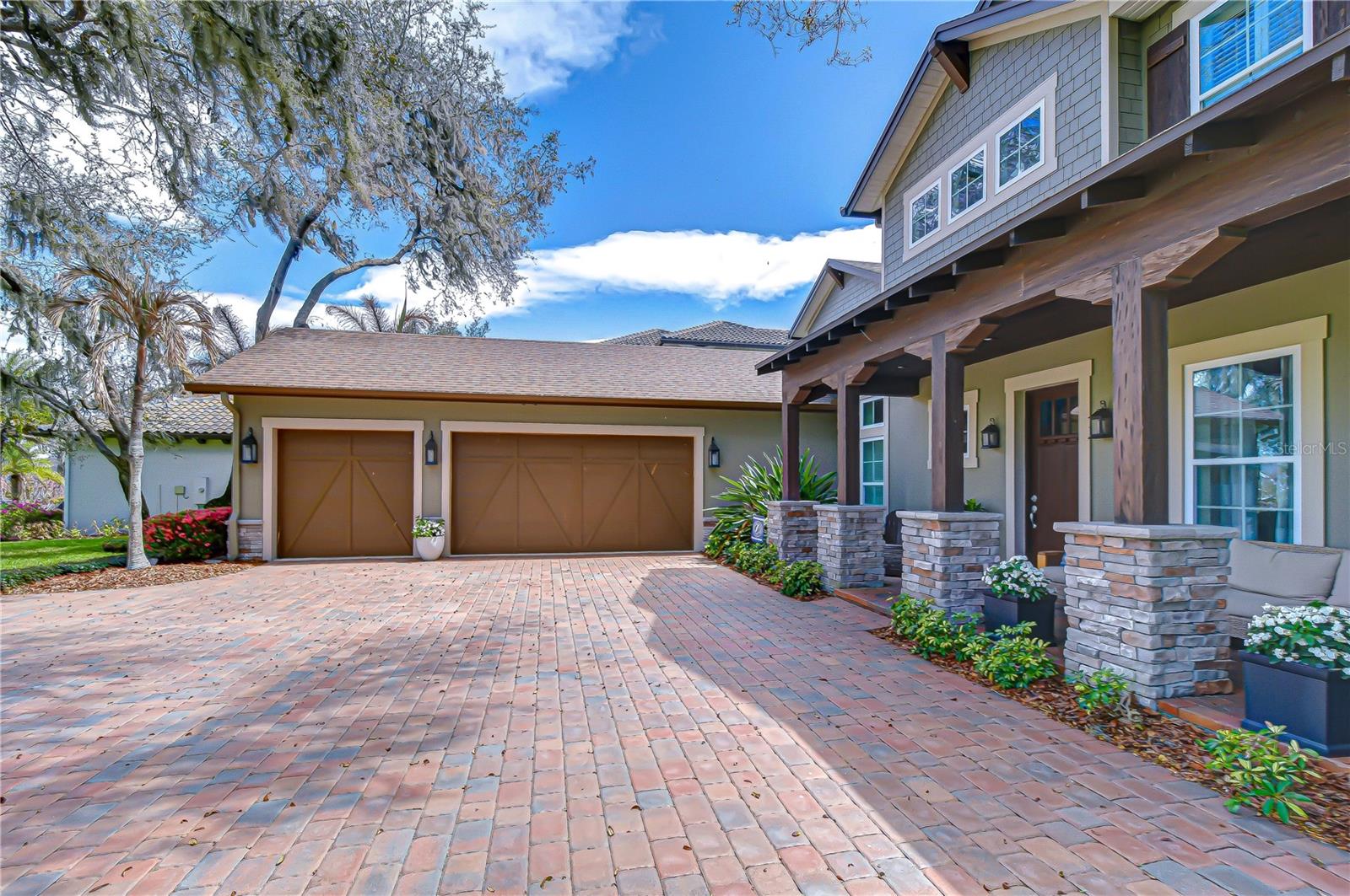 Oversized brick driveway leading to the home’s grand entrance.