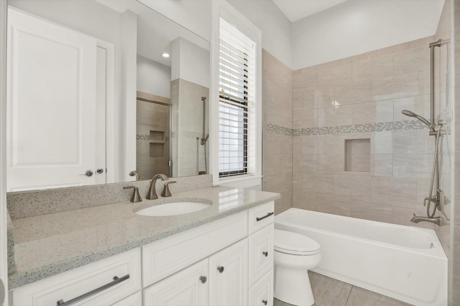 Ensuite bathroom has a walk-in shower and tub.