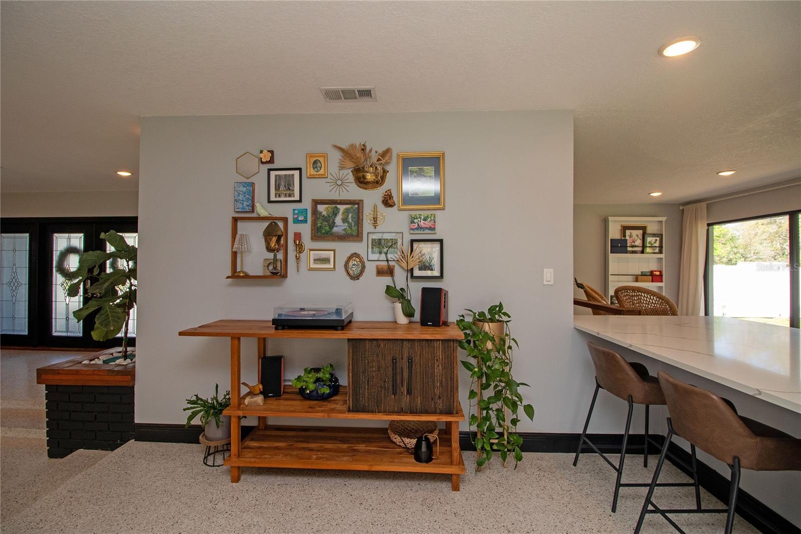 Additional casual sitting area with breakfast bar.