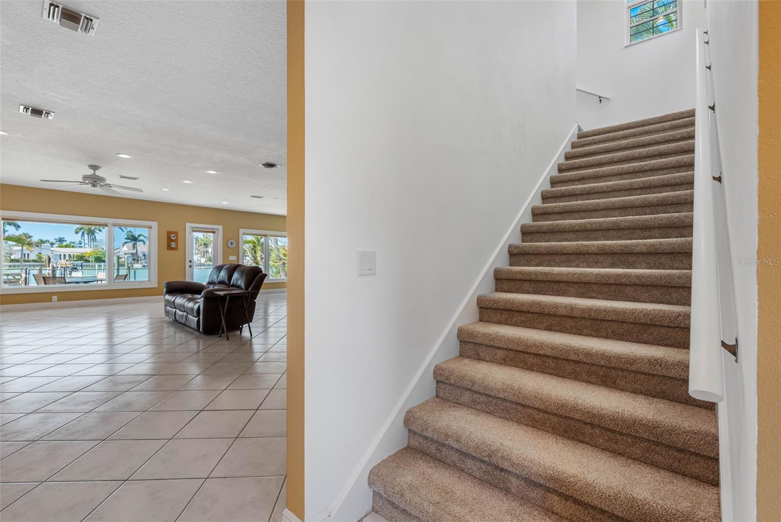 Stairs to the primary suite and office/guest bedroom/nursery.
