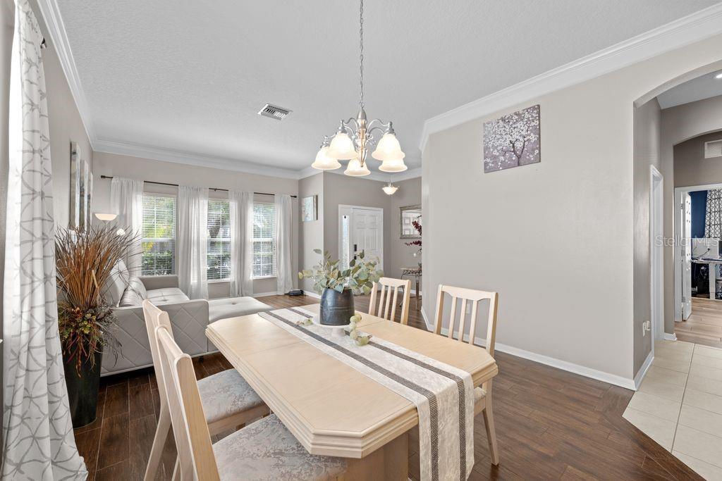 Formal dining area with elegant lighting and open flow