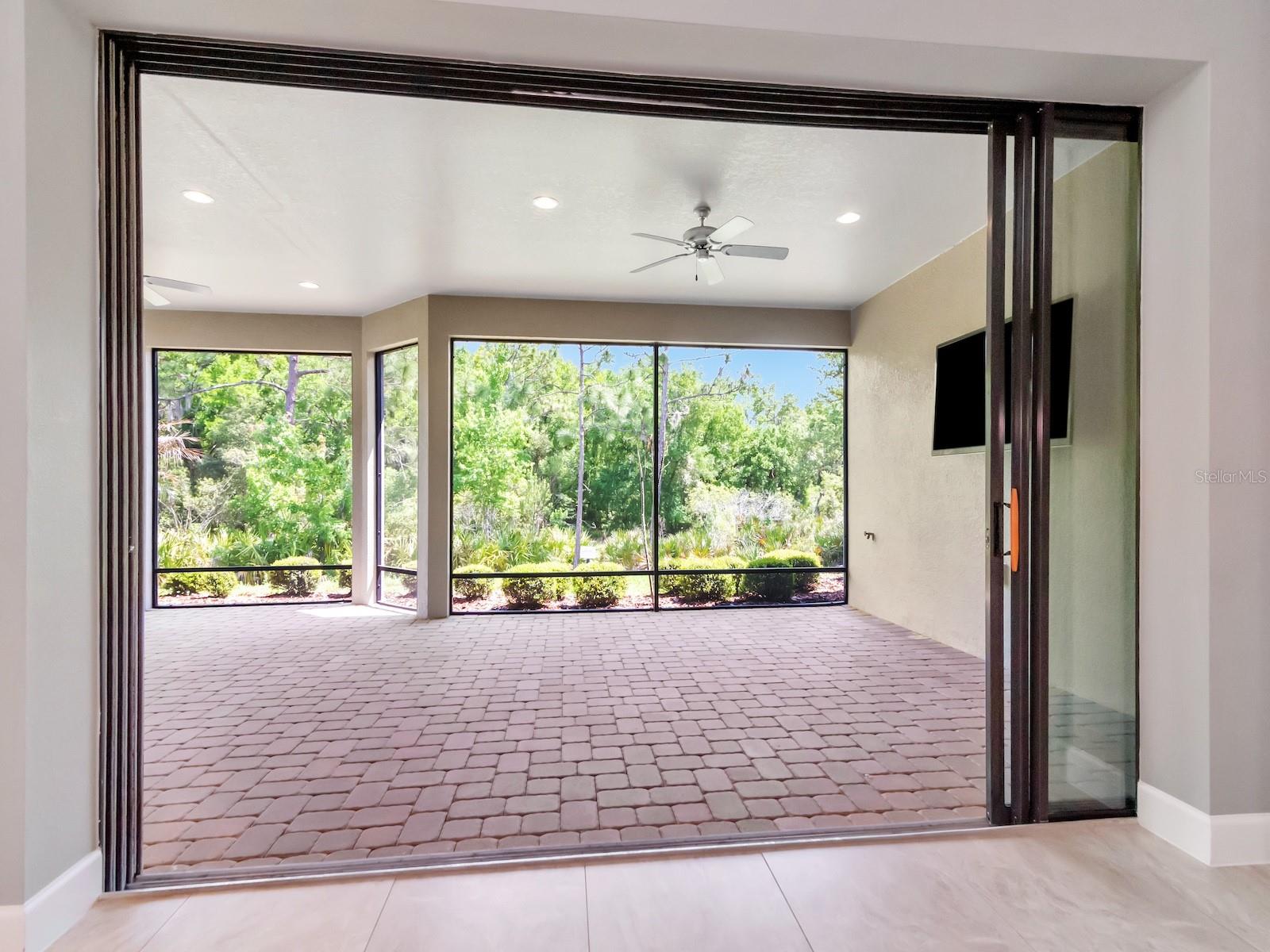 Large extended patio view of conservation behind house