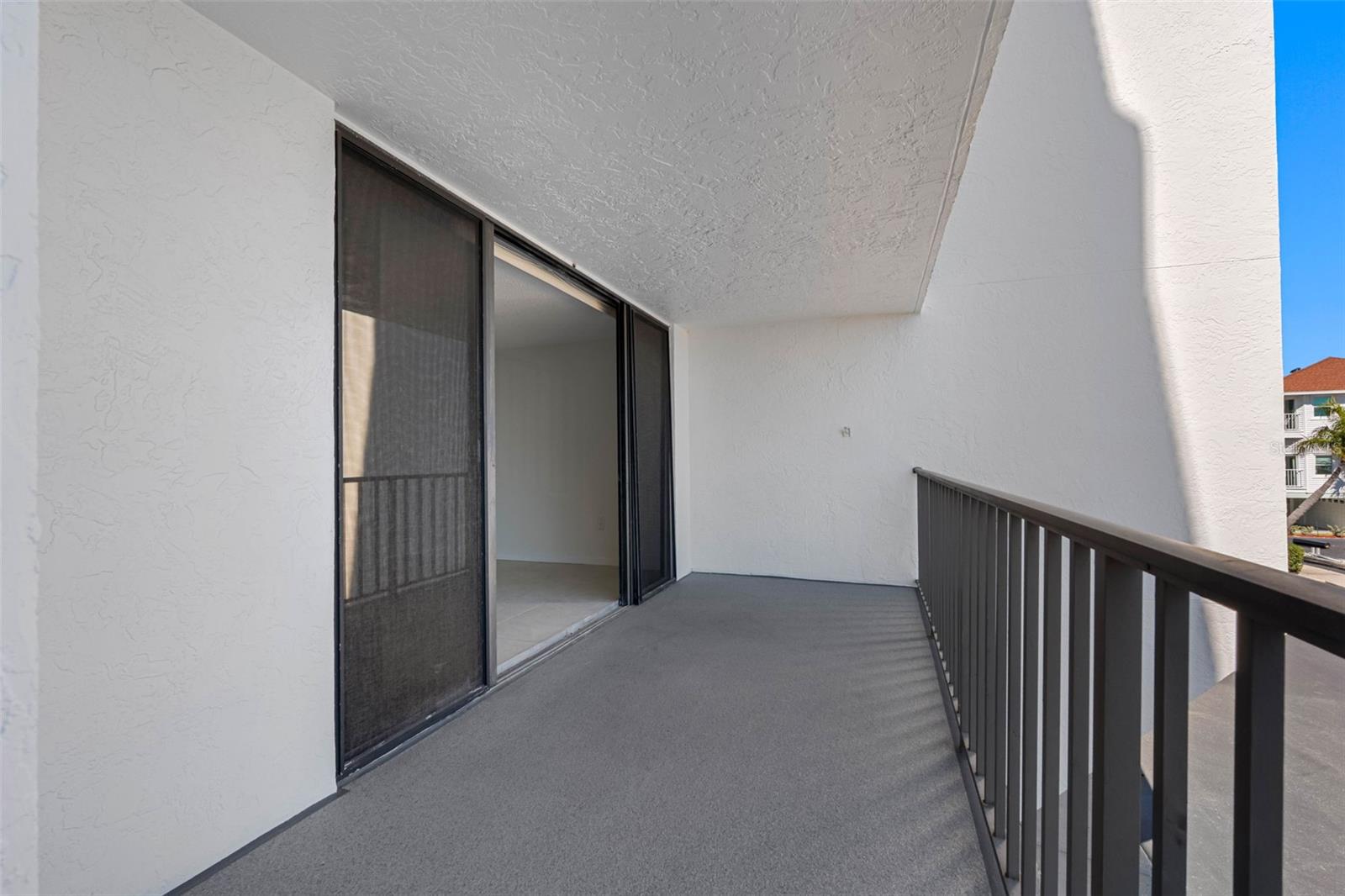 ... Waterfront Balcony looking from the South End Towards the Liivng room with Open Sliders. The 30 Foot length Accomodates both the Liivng Areas and rthe Master Suite..