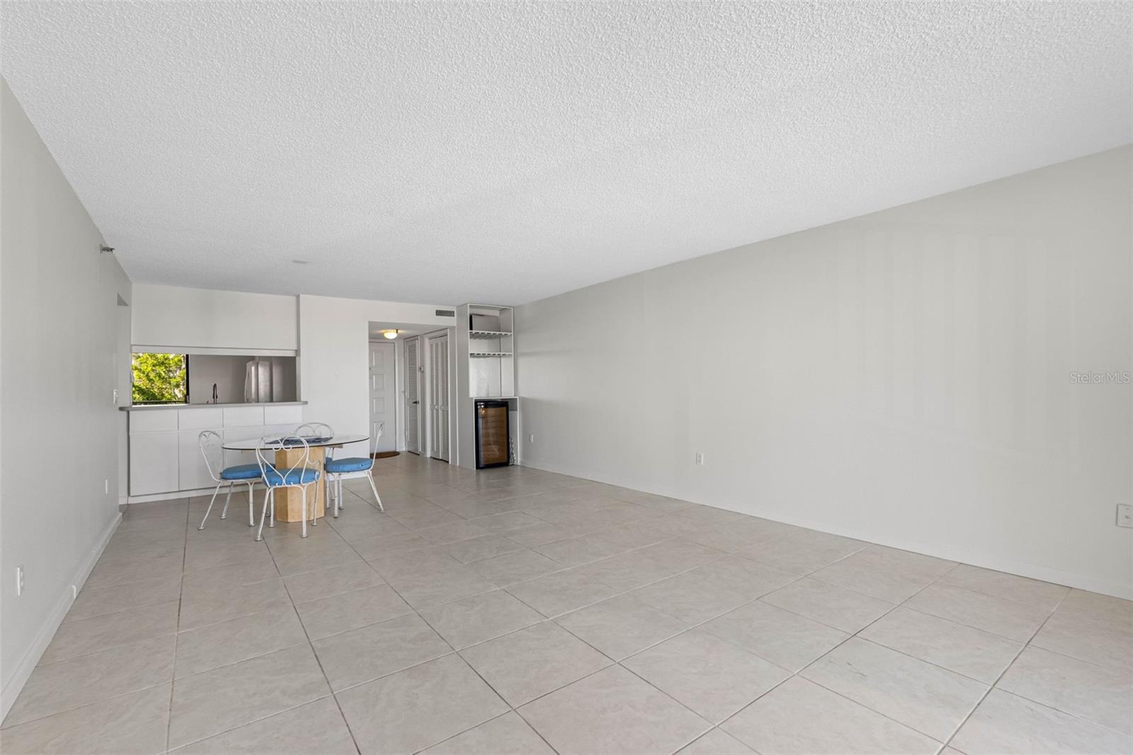 .. Liivng room Area to Dining Room Area..  The Selling Family has owned the unit for over two decades. They emptied the Unit - Had it Professionally Painted -Installed a New A/C System - A New Water Heater - and Priced the Condo at a reasonable dollar number.. All Assessments Paid - Fullly Budgeted Association. Monthly fees at $995..